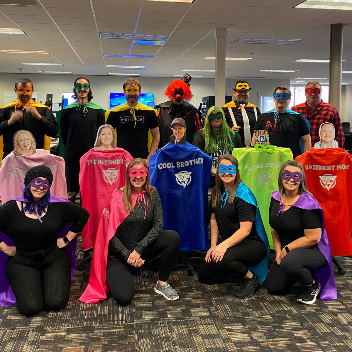 Employees dressed up as superheroes for an event.